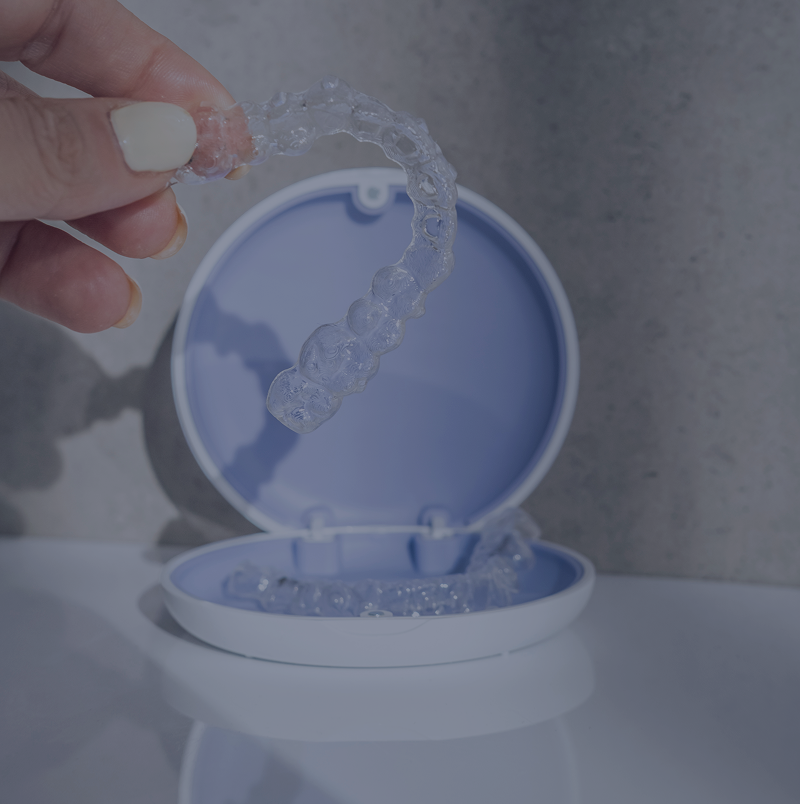 Transparent retainer with blue case on table