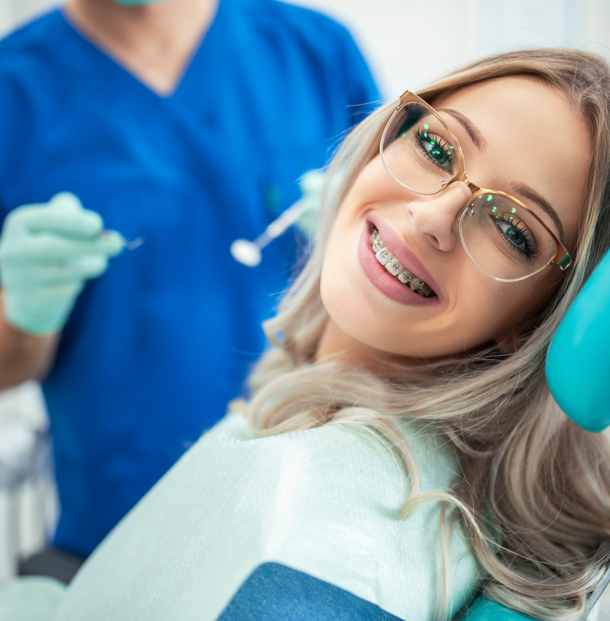 Woman with braces smiling at dentist