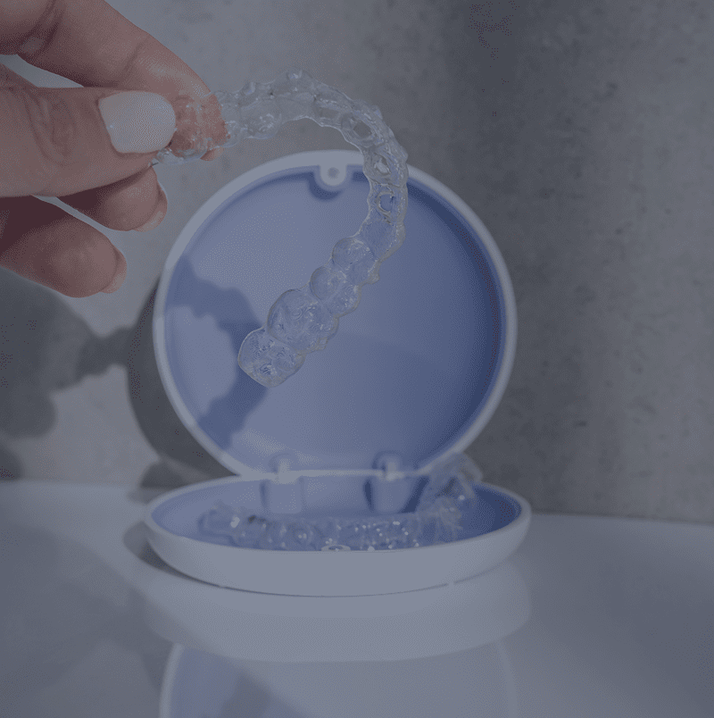 Transparent retainer with blue case on table