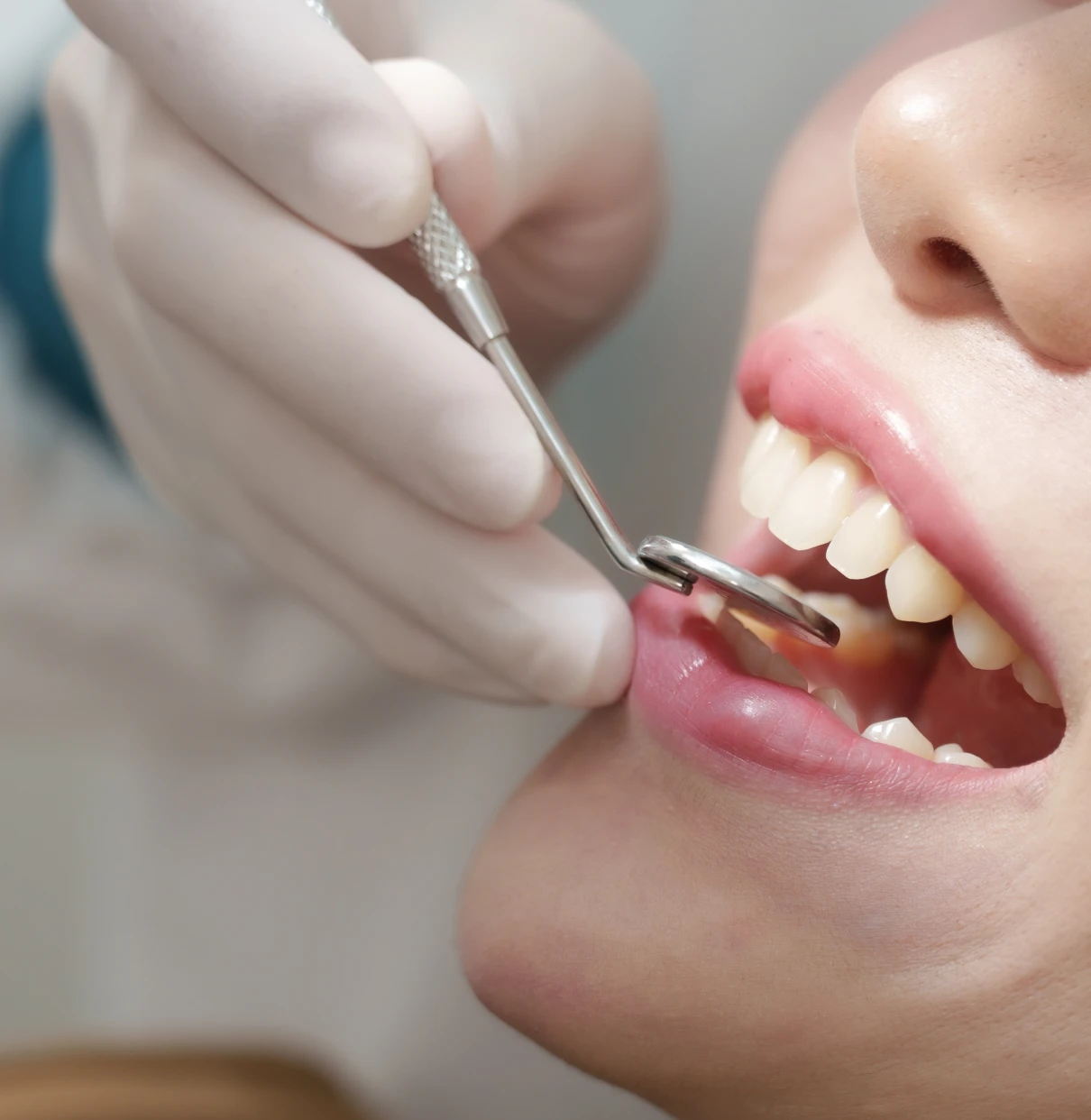 Dentist examining patient's teeth
