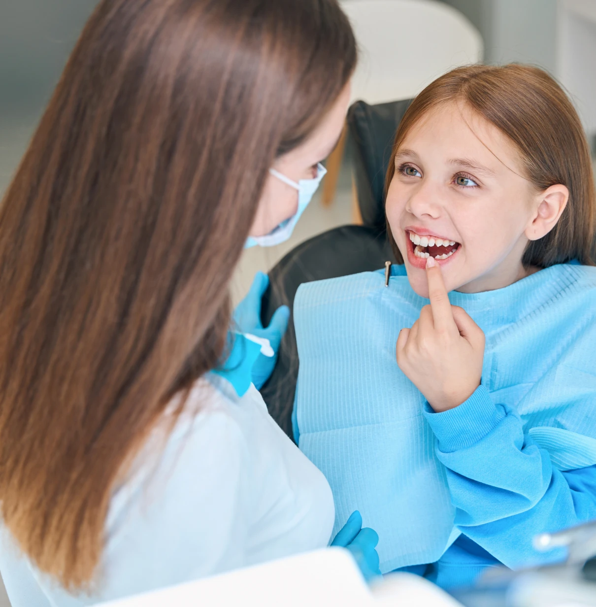 Dentist and child discussing dental care